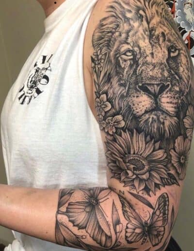 lion flowers and butterflies tattoo , black and grey , statue tattoo , St Augustine tattoo artist